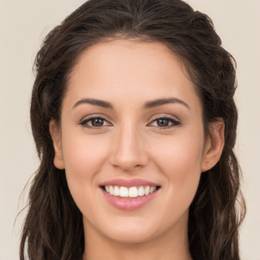 Joyful white young-adult female with long  brown hair and brown eyes