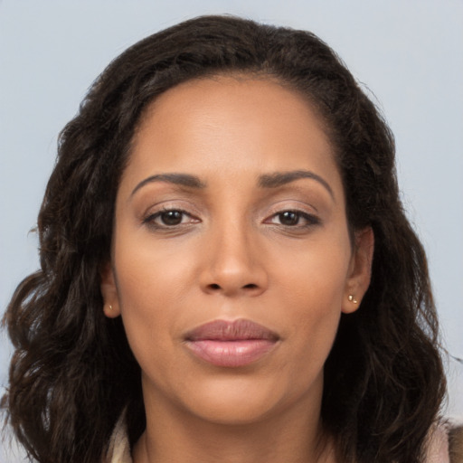 Joyful latino young-adult female with long  brown hair and brown eyes