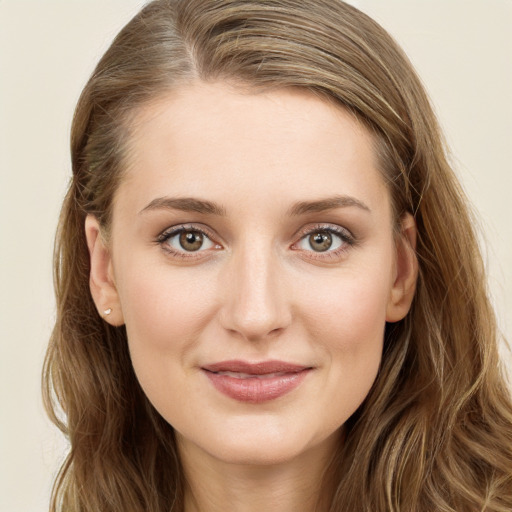 Joyful white young-adult female with long  brown hair and green eyes