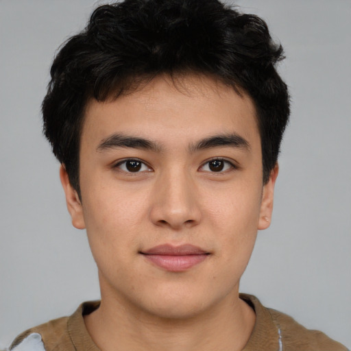 Joyful asian young-adult male with short  brown hair and brown eyes