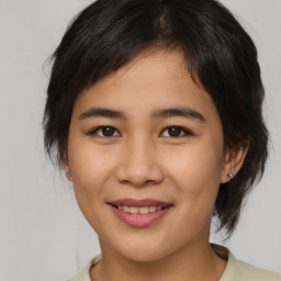 Joyful asian young-adult female with medium  brown hair and brown eyes