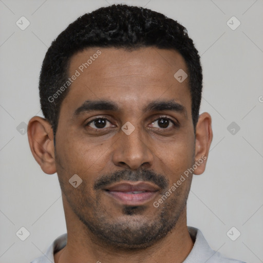 Joyful black young-adult male with short  black hair and brown eyes