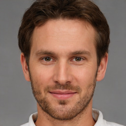 Joyful white adult male with short  brown hair and brown eyes