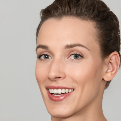 Joyful white young-adult female with short  brown hair and brown eyes