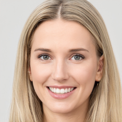 Joyful white young-adult female with long  brown hair and blue eyes