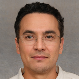 Joyful white adult male with short  black hair and brown eyes