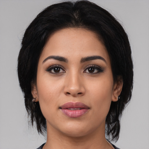 Joyful latino young-adult female with medium  black hair and brown eyes