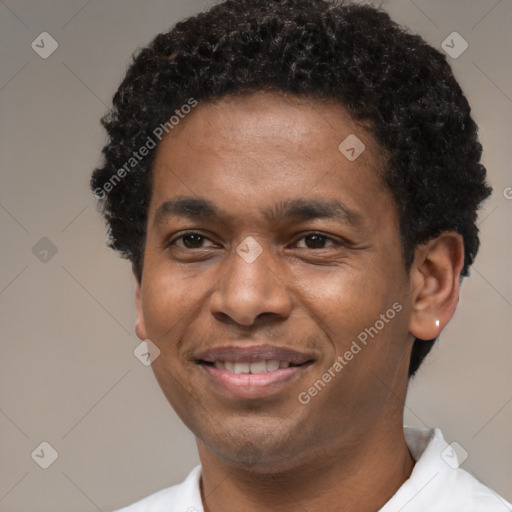 Joyful black young-adult male with short  brown hair and brown eyes