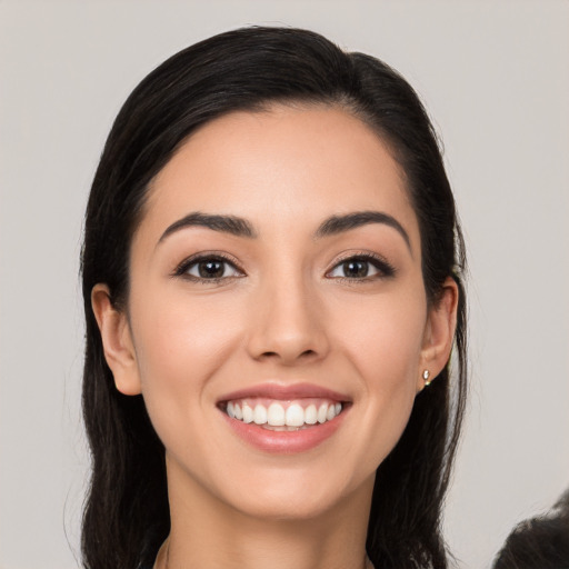 Joyful white young-adult female with long  black hair and brown eyes