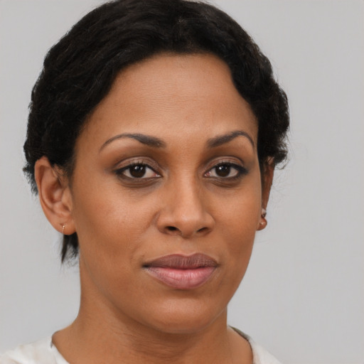 Joyful black young-adult female with short  brown hair and brown eyes