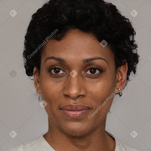 Joyful black adult female with short  black hair and brown eyes