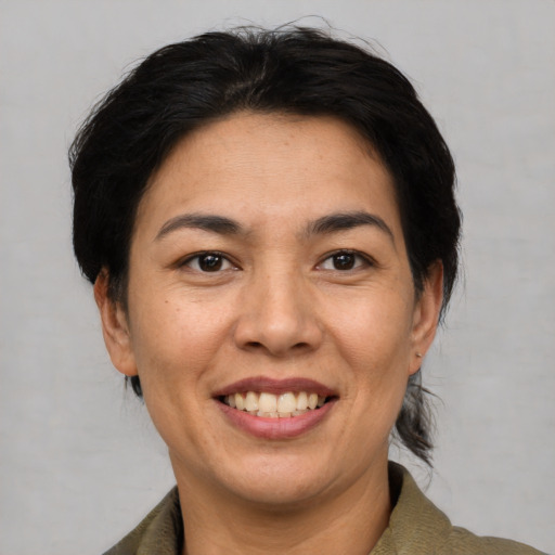 Joyful asian adult female with short  brown hair and brown eyes