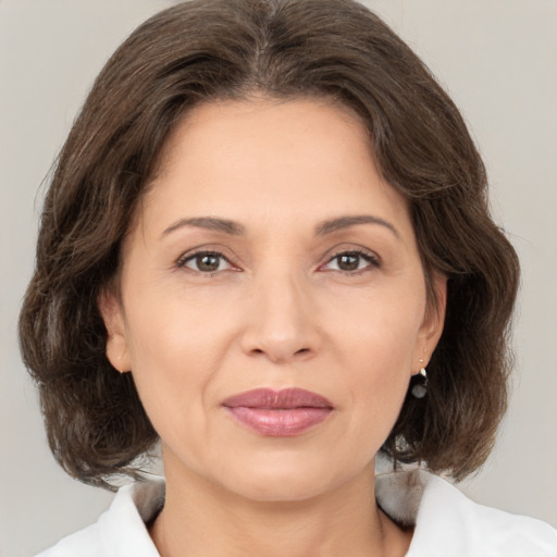 Joyful white adult female with medium  brown hair and brown eyes