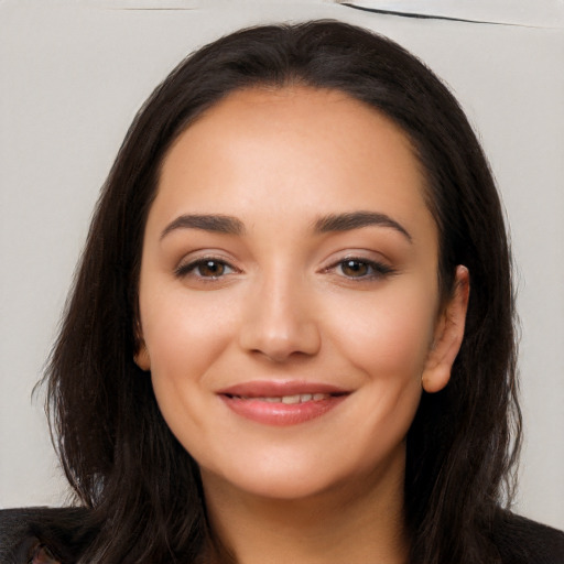 Joyful latino young-adult female with long  black hair and brown eyes