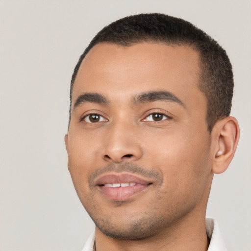 Joyful latino young-adult male with short  black hair and brown eyes