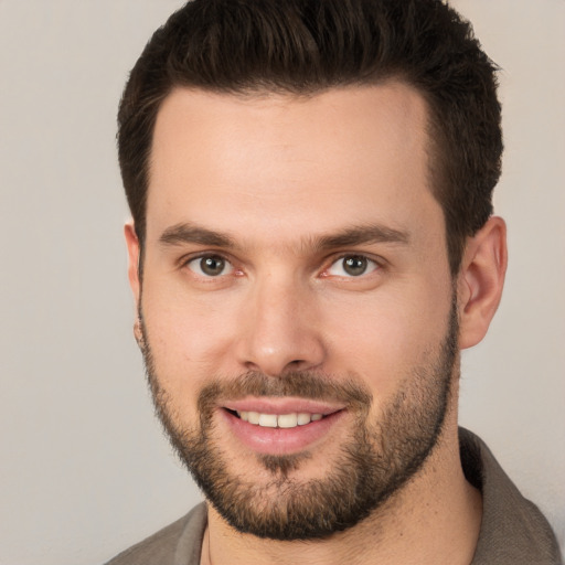 Joyful white young-adult male with short  brown hair and brown eyes