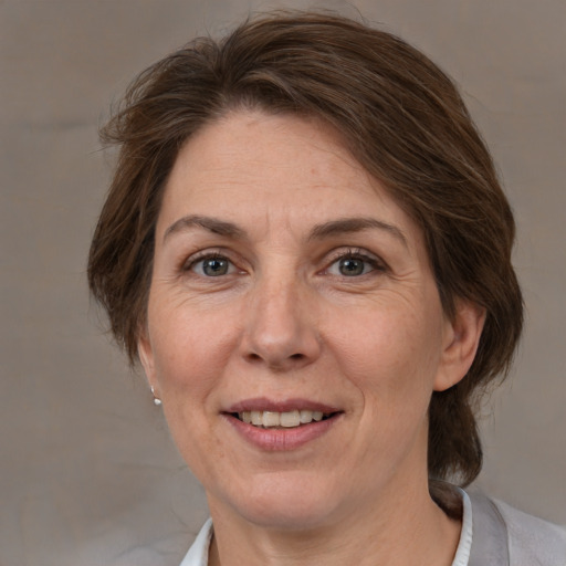 Joyful white adult female with medium  brown hair and brown eyes