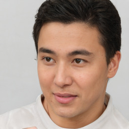 Joyful asian young-adult male with short  brown hair and brown eyes