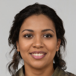 Joyful latino young-adult female with long  brown hair and brown eyes