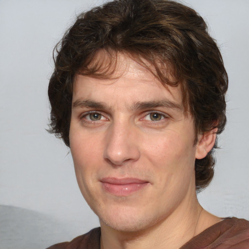 Joyful white adult male with medium  brown hair and brown eyes