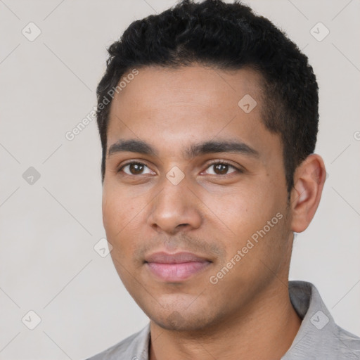 Joyful latino young-adult male with short  black hair and brown eyes