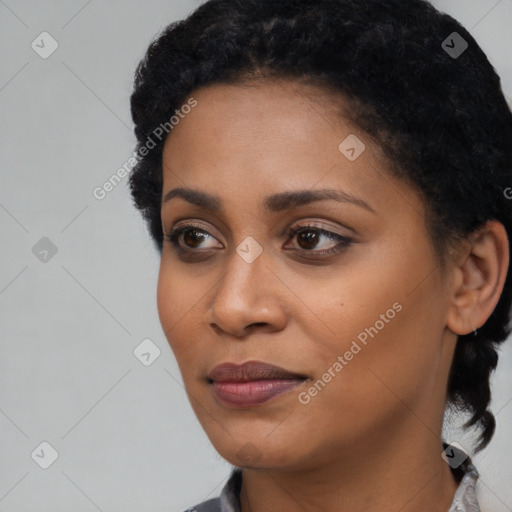 Joyful black young-adult female with short  black hair and brown eyes