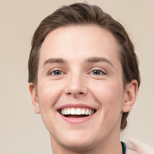 Joyful white young-adult male with medium  brown hair and green eyes