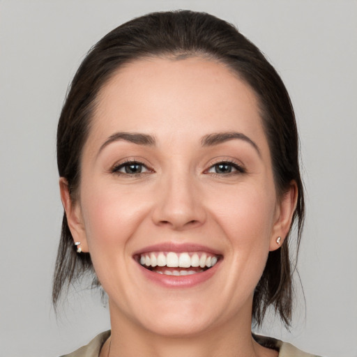 Joyful white young-adult female with medium  brown hair and brown eyes