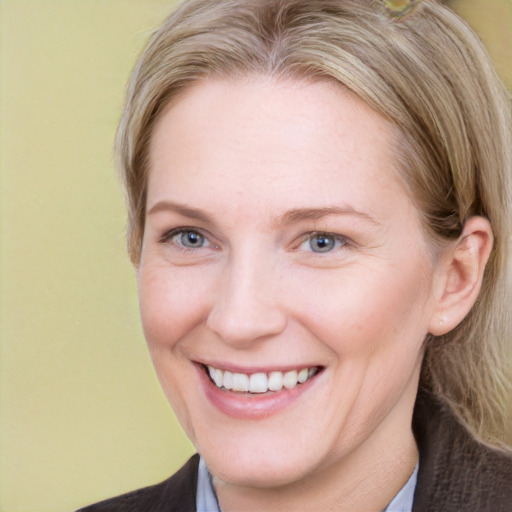 Joyful white adult female with medium  brown hair and blue eyes