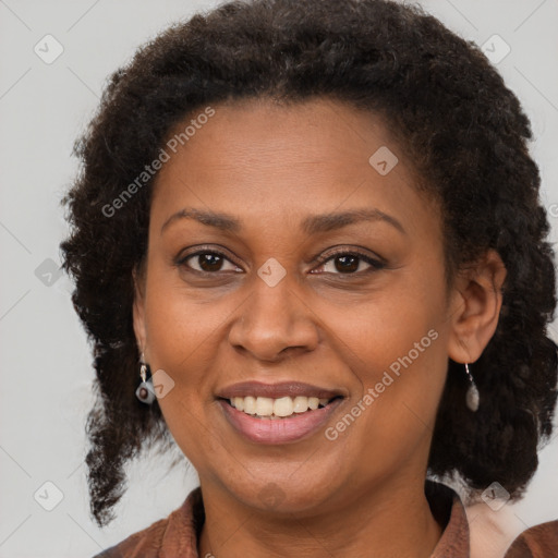 Joyful black adult female with medium  brown hair and brown eyes