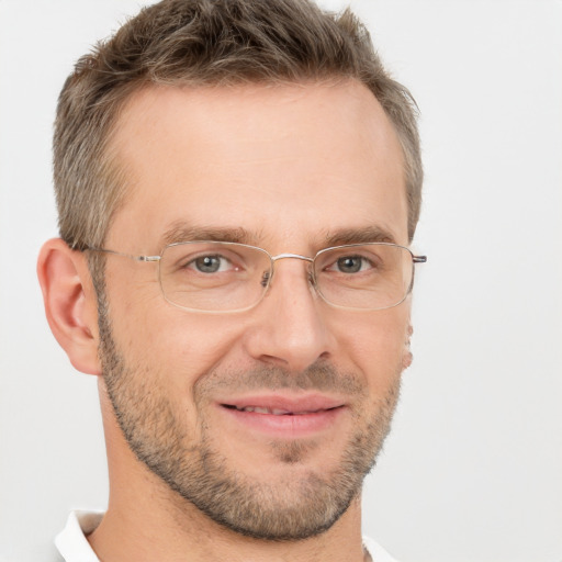 Joyful white adult male with short  brown hair and brown eyes