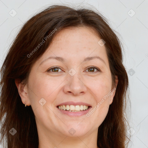 Joyful white adult female with long  brown hair and brown eyes