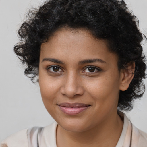 Joyful black young-adult female with medium  brown hair and brown eyes