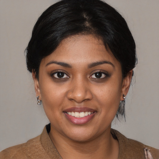 Joyful black young-adult female with medium  brown hair and brown eyes
