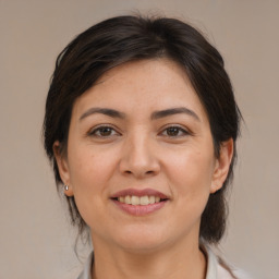 Joyful white adult female with medium  brown hair and brown eyes