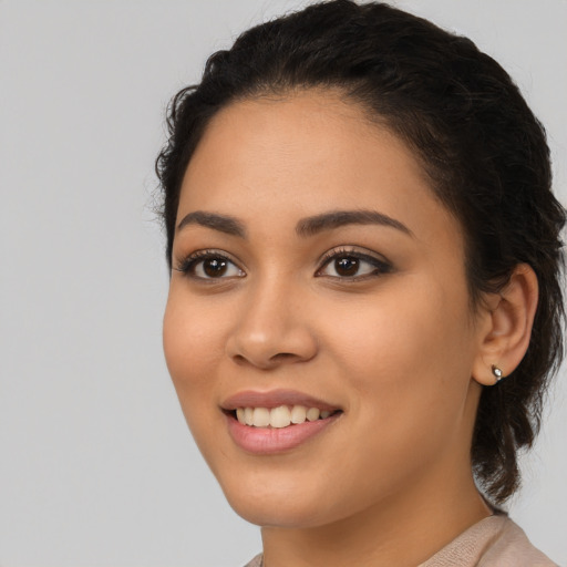 Joyful latino young-adult female with medium  black hair and brown eyes