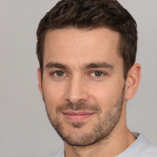 Joyful white young-adult male with short  brown hair and brown eyes