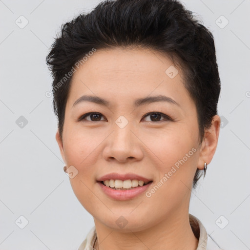 Joyful asian young-adult female with short  brown hair and brown eyes