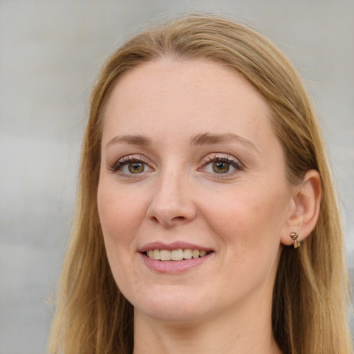 Joyful white young-adult female with long  brown hair and blue eyes