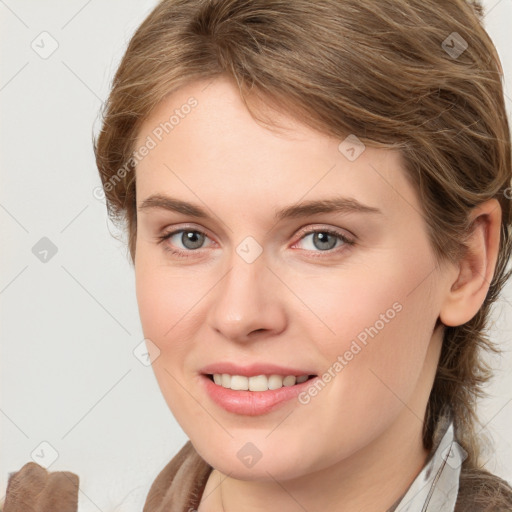 Joyful white young-adult female with medium  brown hair and blue eyes