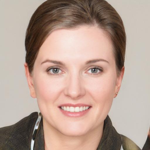 Joyful white young-adult female with short  brown hair and grey eyes