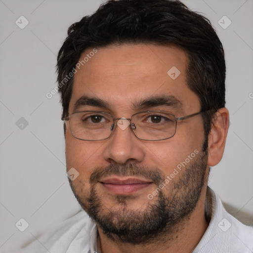 Joyful white adult male with short  black hair and brown eyes