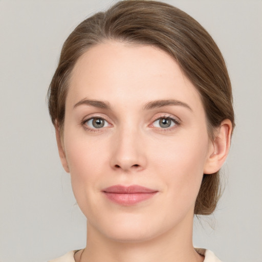 Joyful white young-adult female with medium  brown hair and grey eyes