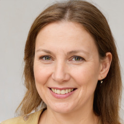 Joyful white adult female with long  brown hair and brown eyes