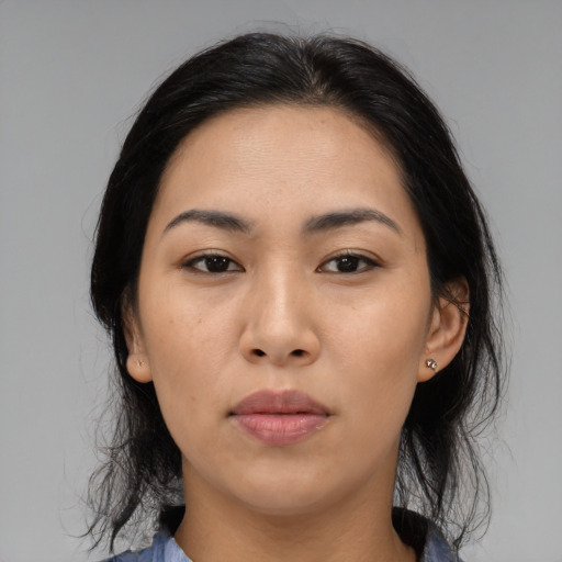 Joyful asian young-adult female with medium  black hair and brown eyes