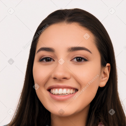 Joyful white young-adult female with long  black hair and brown eyes