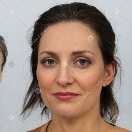 Joyful white adult female with medium  brown hair and brown eyes