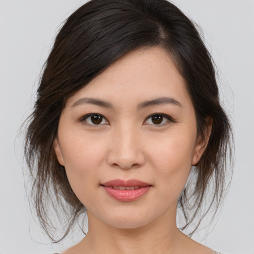 Joyful asian young-adult female with medium  brown hair and brown eyes