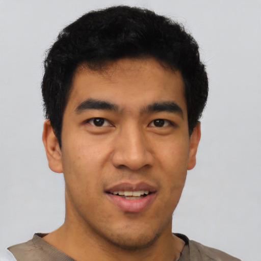 Joyful asian young-adult male with short  black hair and brown eyes