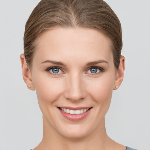 Joyful white young-adult female with short  brown hair and grey eyes